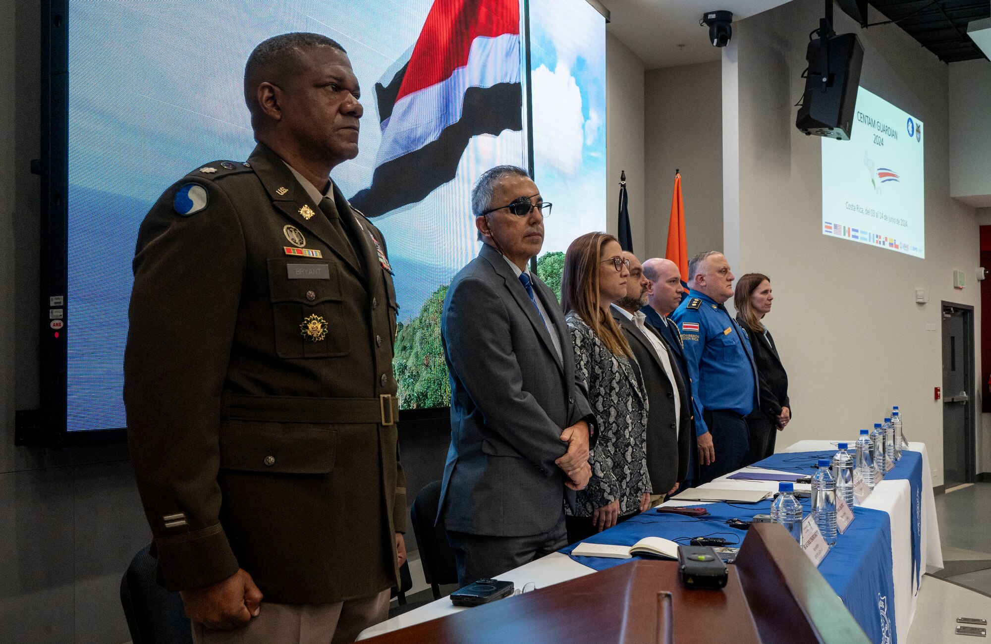 A photo of people standing at a table.