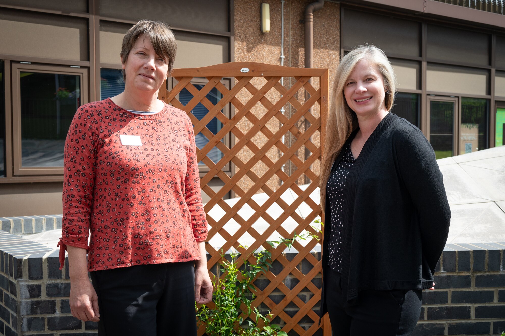 Jenefer L. Kepple, 422 Air Base Group librarian, right, and Lisa D. Oliver, 422 Air Base Group library technician, left, pose at the library courtyard
