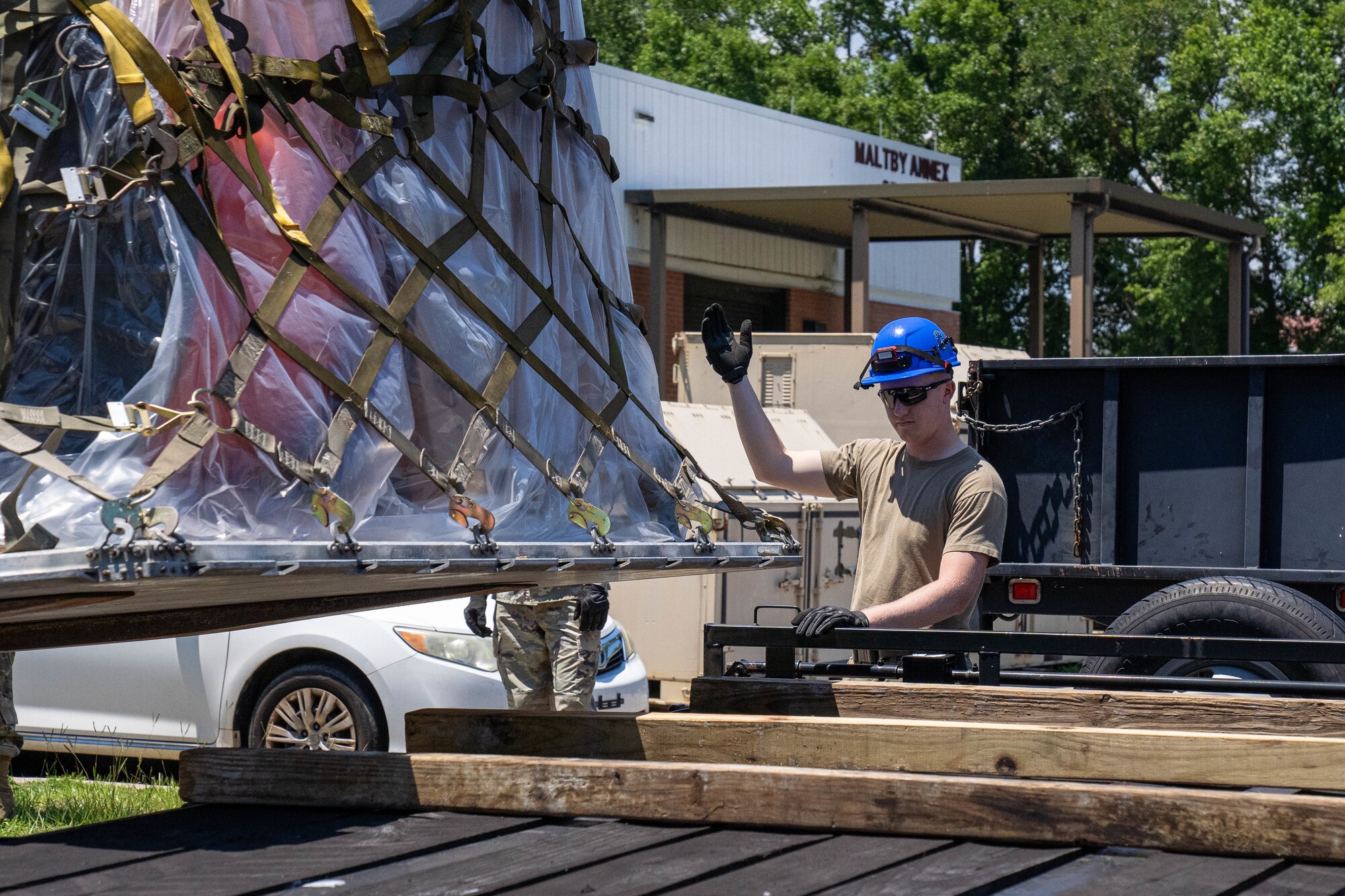 U.S. Air Force Staff Sgt. Collin Swiger, 85th Engineering Installation Squadron radar, airfield and weather systems specialist supervisor, guides a forklift placing a palette on a flatbed truck at the 85th EIS, Mississippi, May 20, 2024.