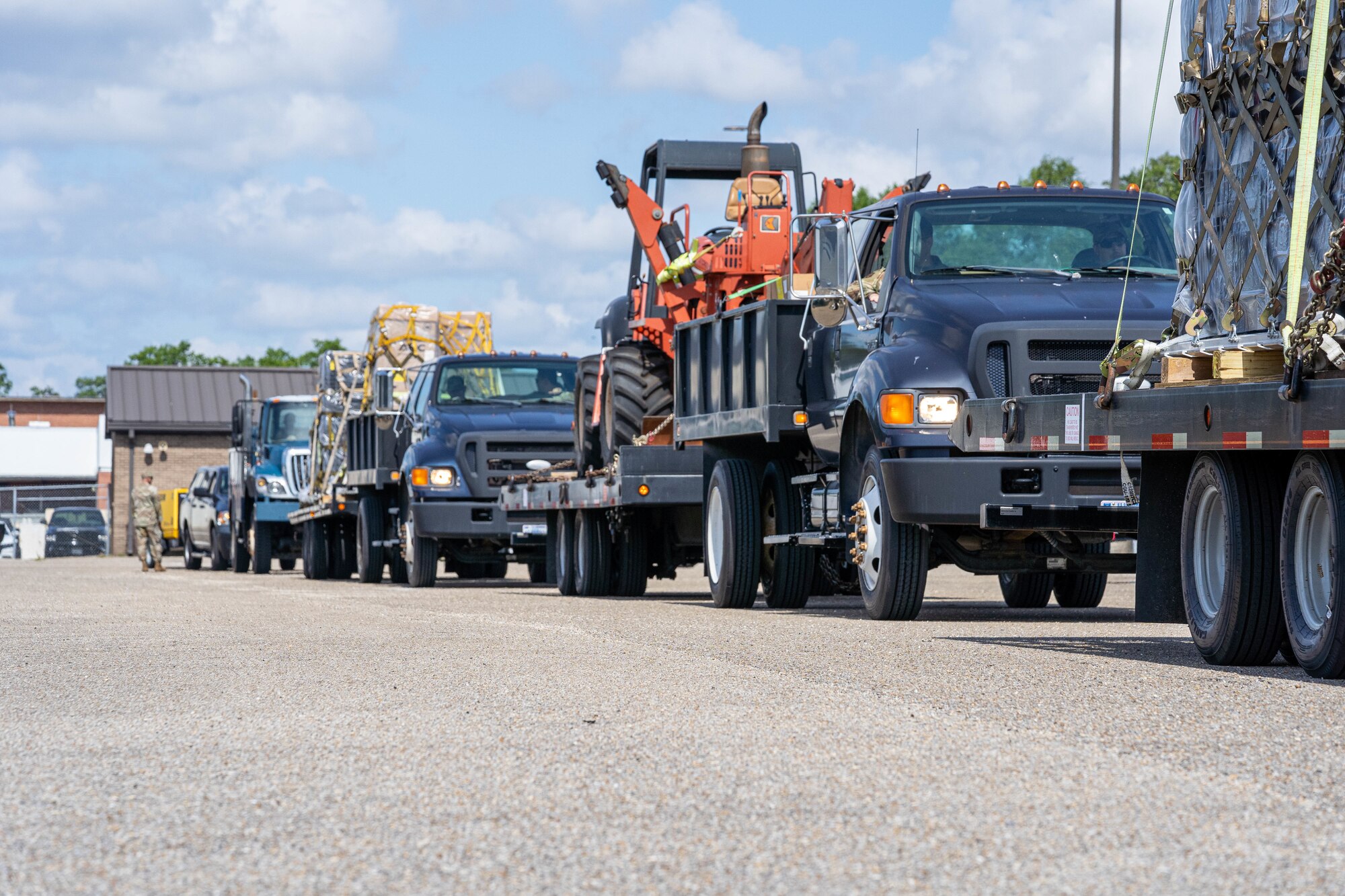 Multiple vehicles carrying heavy equipment head to another installation for the Cyberspace Infrastructure Damage Assessment and Restoral Actions Exercise at the 85th Engineering Installation Squadron, May 21, 2024.