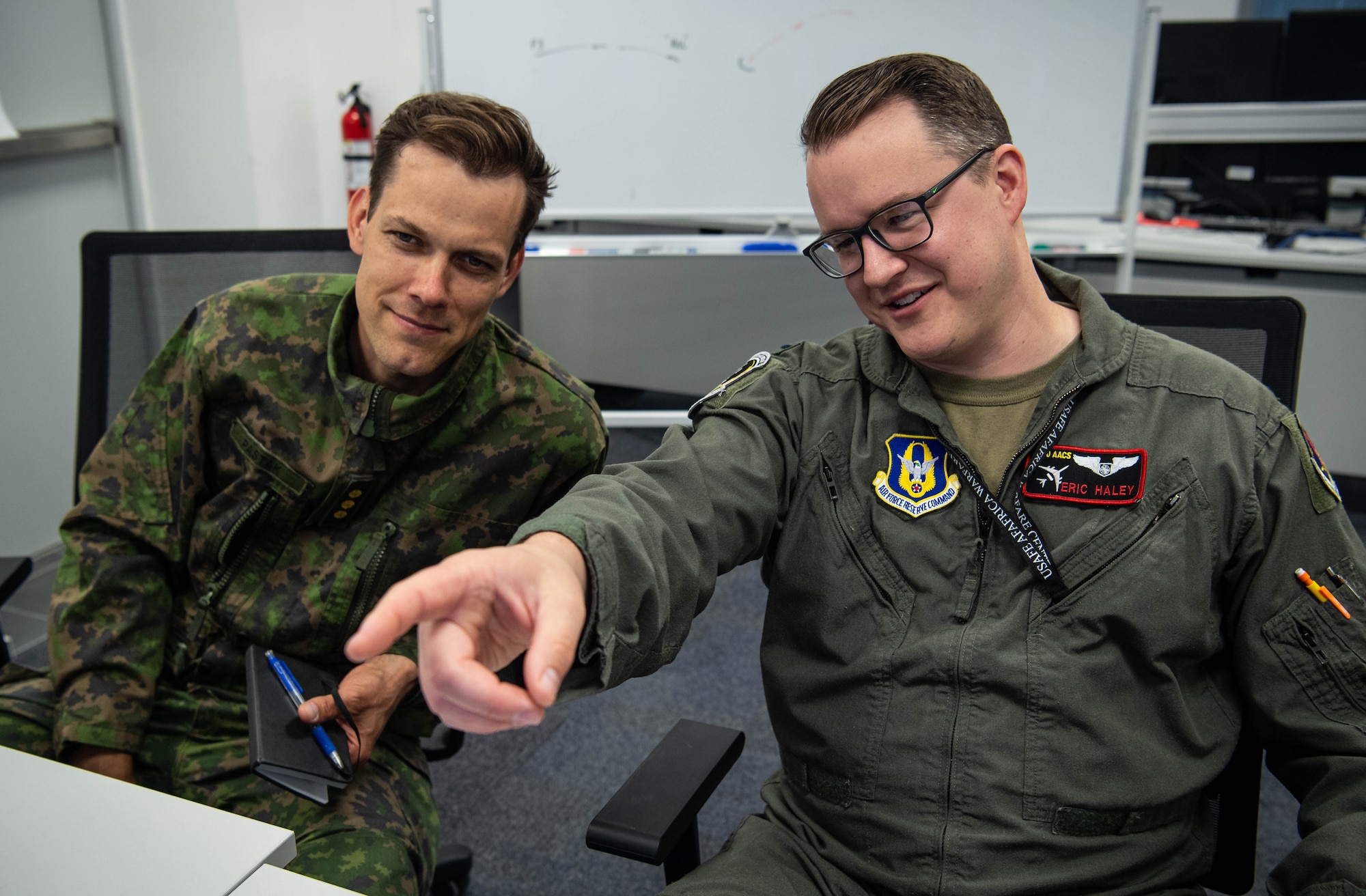 Finnish Air Force Capt. Ville Pastak, left, Air Combat Center element lead, and U.S. Air Force 1st Lt. Eric Haley, right, 5th Combat Training Squadron exercise planner, participate in exercise Ramstein Flag-Virtual 2024 at Einsiedlerhof Air Base, Germany, June 3, 2024. Ramstein Flag-Virtual 2024 is the first United States Air Forces in Europe – Air Forces Africa Warfare Center rehearsal for a live-fly exercise. The exercise enabled participants to receive an introduction of a live-flight mission and environment to achieve higher levels of effectiveness in a real world scenario. (U.S. Air Force photo by Senior Airman Jared Lovett)