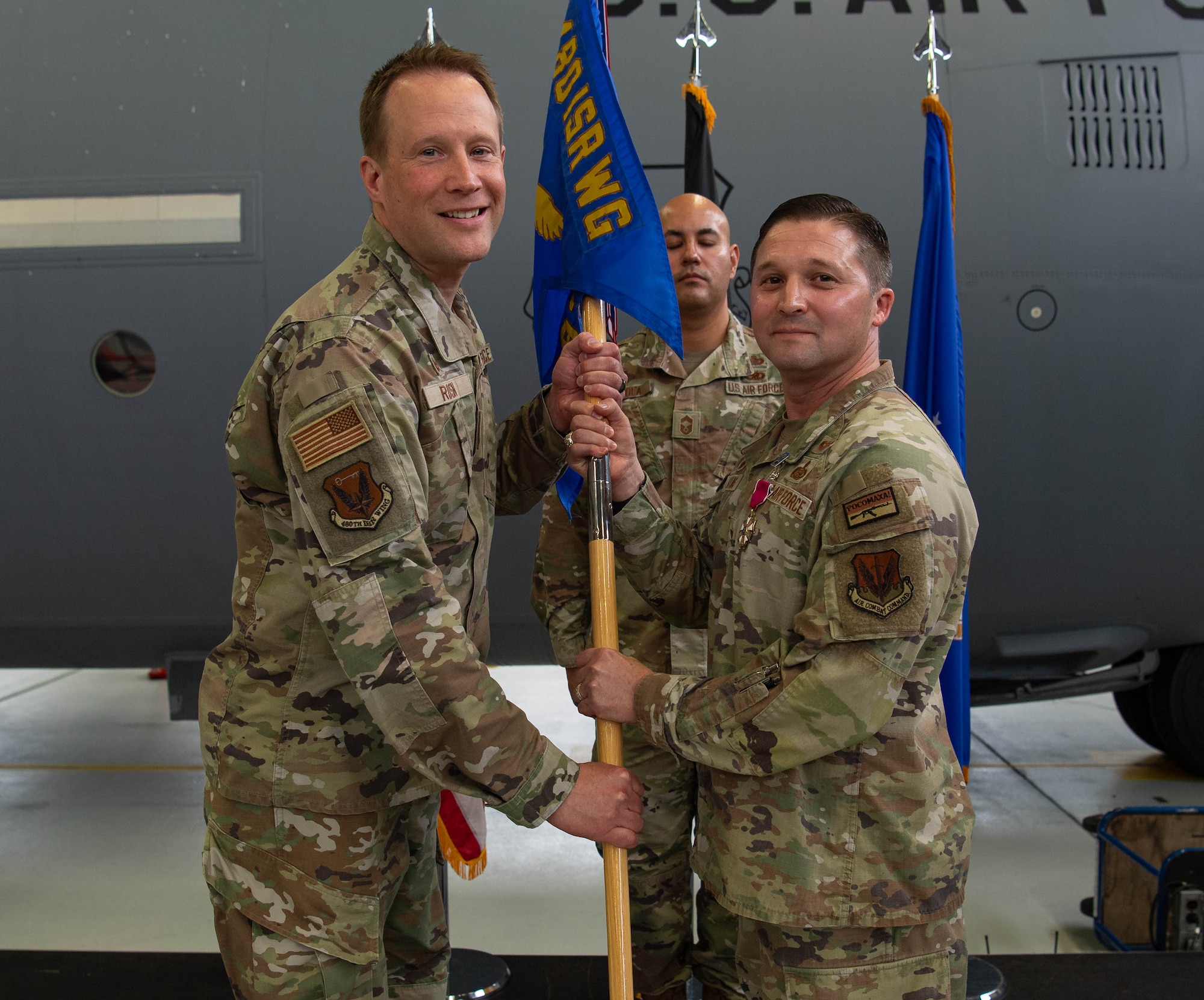 U.S. Air Force Col. Creighton Mullins, right, 693rd Intelligence, Surveillance and Reconnaissance Group outgoing commander relinquishes command of the 693rd ISRG to Col. Nathan Rusin, left, 480th Intelligence, Surveillance and Reconnaissance Wing commander, during the 693rd ISRG change of command ceremony at Ramstein Air Base, Germany, June 6, 2024. The mission of the 693rd ISRG is to lead theater Air Force ISR operations through effective planning, collection, analysis and dissemination, enabling theater and national warfighters to secure global vigilance, reach and power. (U.S. Air Force photo by Senior Airman Jared Lovett)