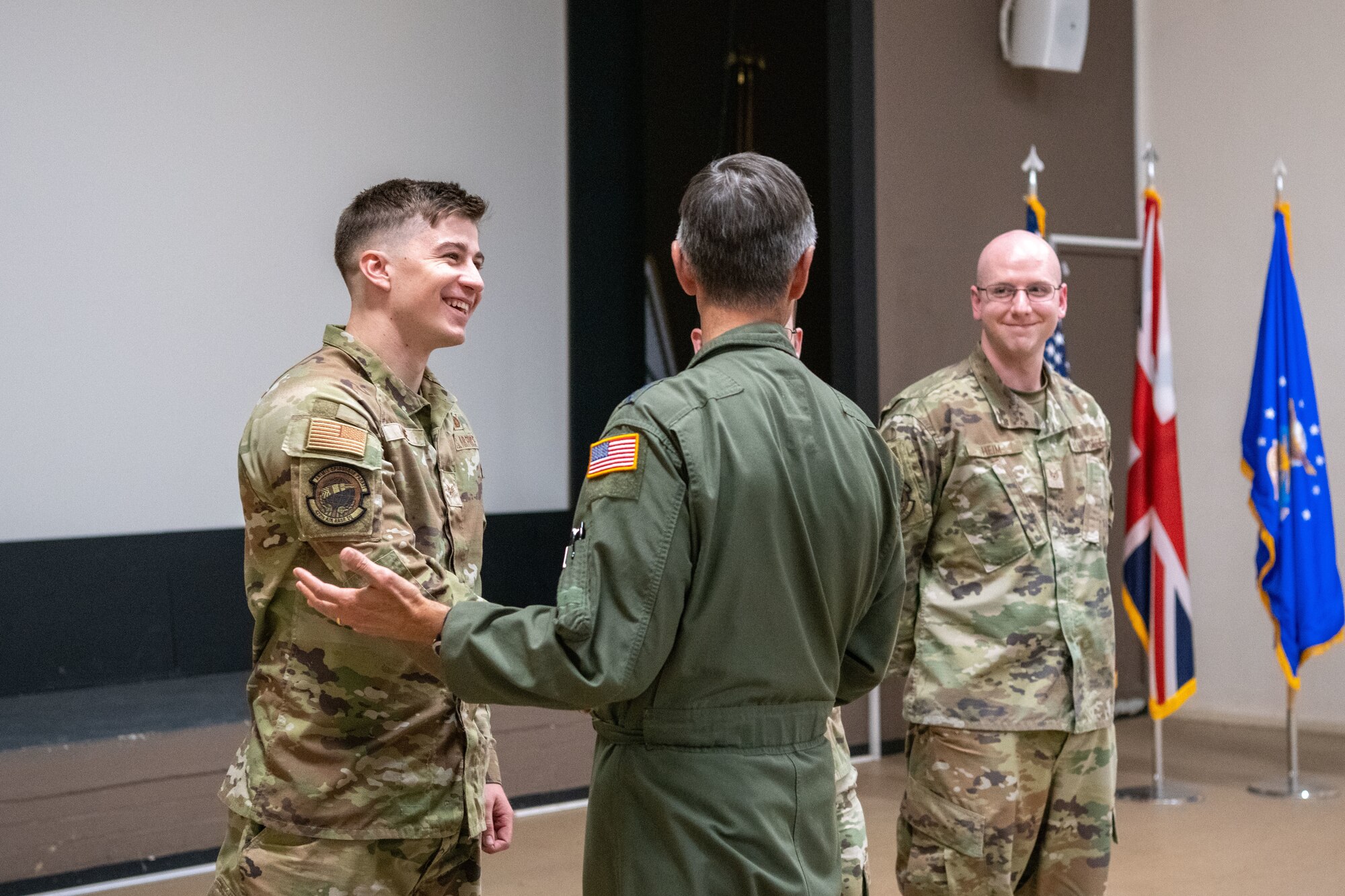 Airmen smile while being recognized during an all-call