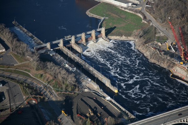 An aerial image of a lock and dam on a river