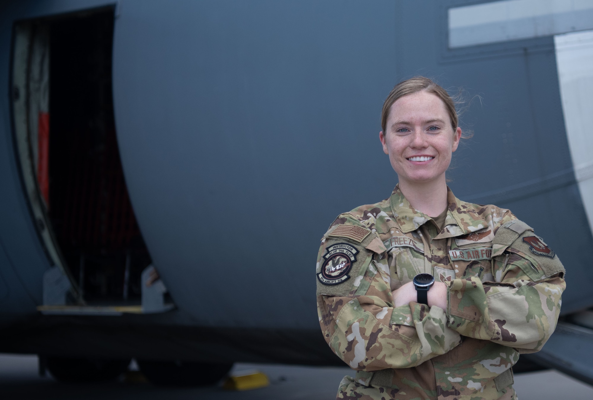 A woman poses for photo outside plane