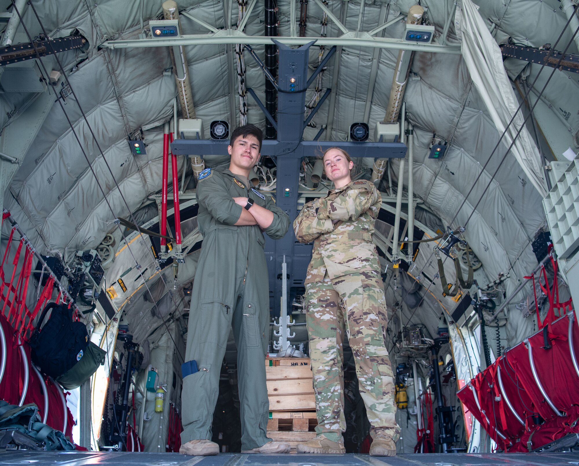 Two people pose inside plane for a photo