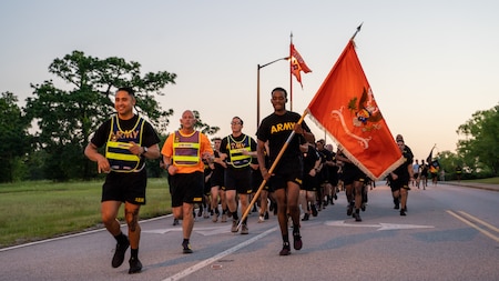 Soldiers from 369th Signal Battalion, 15th Signal Brigade, run in formation during Fort Eisenhower's 5k fun run celebrating the 249th birthday of the U.S. Army, June 14, 2024.
