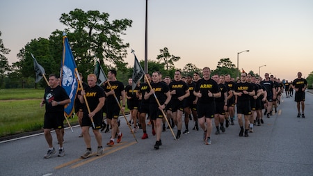 Soldiers from Cyber Center of Excellence Noncommissioned Officers Academy run in formation during Fort Eisenhower's 5k fun run celebrating the 249th birthday of the U.S. Army, June 14, 2024.