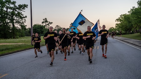 Soldiers run in formation during Fort Eisenhower's 5k fun run celebrating the 249th birthday of the U.S. Army, June 14, 2024.