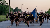 Soldiers from the 706th Military Intelligence Battalion run in formation during Fort Eisenhower's 5k fun run celebrating the 249th birthday of the U.S. Army, June 14, 2024.