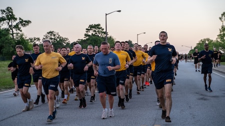 Sailors from Navy Information Operations Command, Georgia run in formation during Fort Eisenhower's 5k fun run celebrating the 249th birthday of the U.S. Army, June 14, 2024.