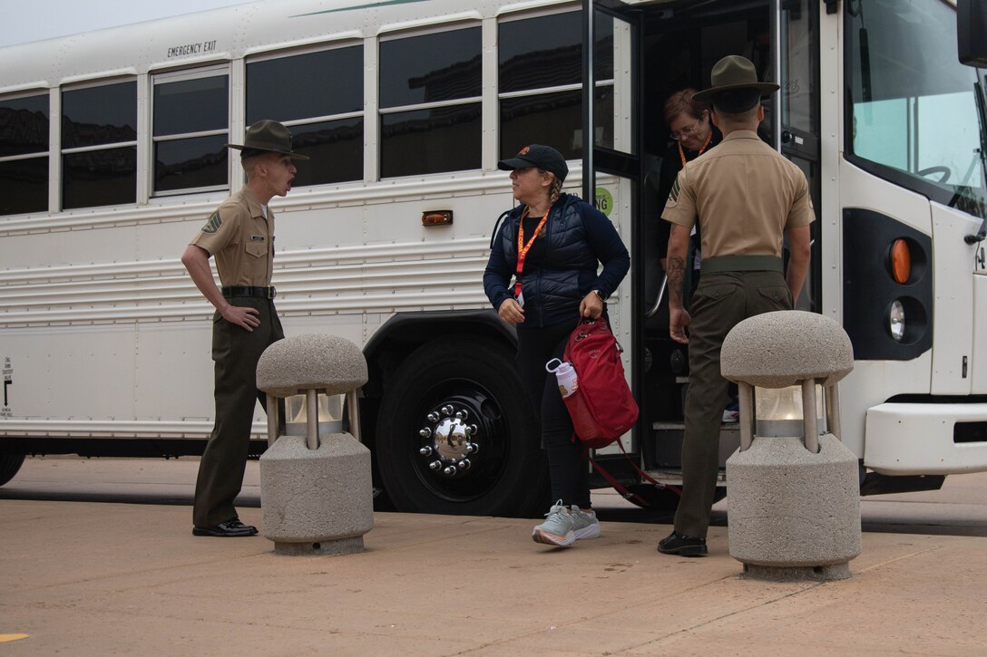 Educators from Recruiting Stations Los Angeles, Orange County, Riverside, and Sacramento exit a bus during a mock receiving event as part of the 2024 Educators Workshop at Marine Corps Recruit Depot San Diego, California, June 4, 2024. Participants of the workshop visited MCRD San Diego to observe recruit training and gain a better understanding about the transformation process recruits undergo to become United States Marines. Educators also received classes and briefs on the benefits that are provided to service members in the United States armed forces. (U.S. Marine Corps photo by Cpl. Elliott A. Flood-Johnson)