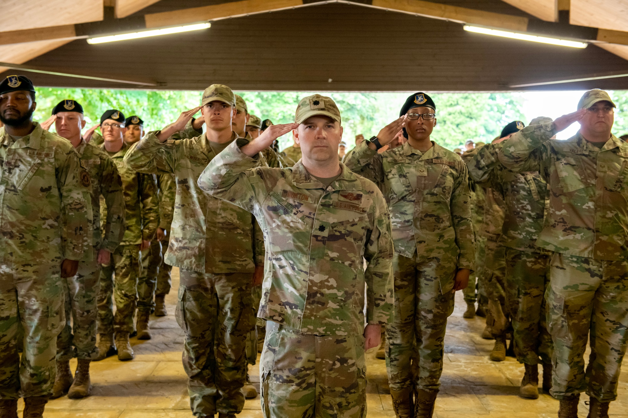 U.S. Air Force Lt. Col. Gary Morton, center, 422d Air Base Group deputy commander, and Airmen from the 422d ABG, render a first salute to the incoming commander during an assumption of command ceremony