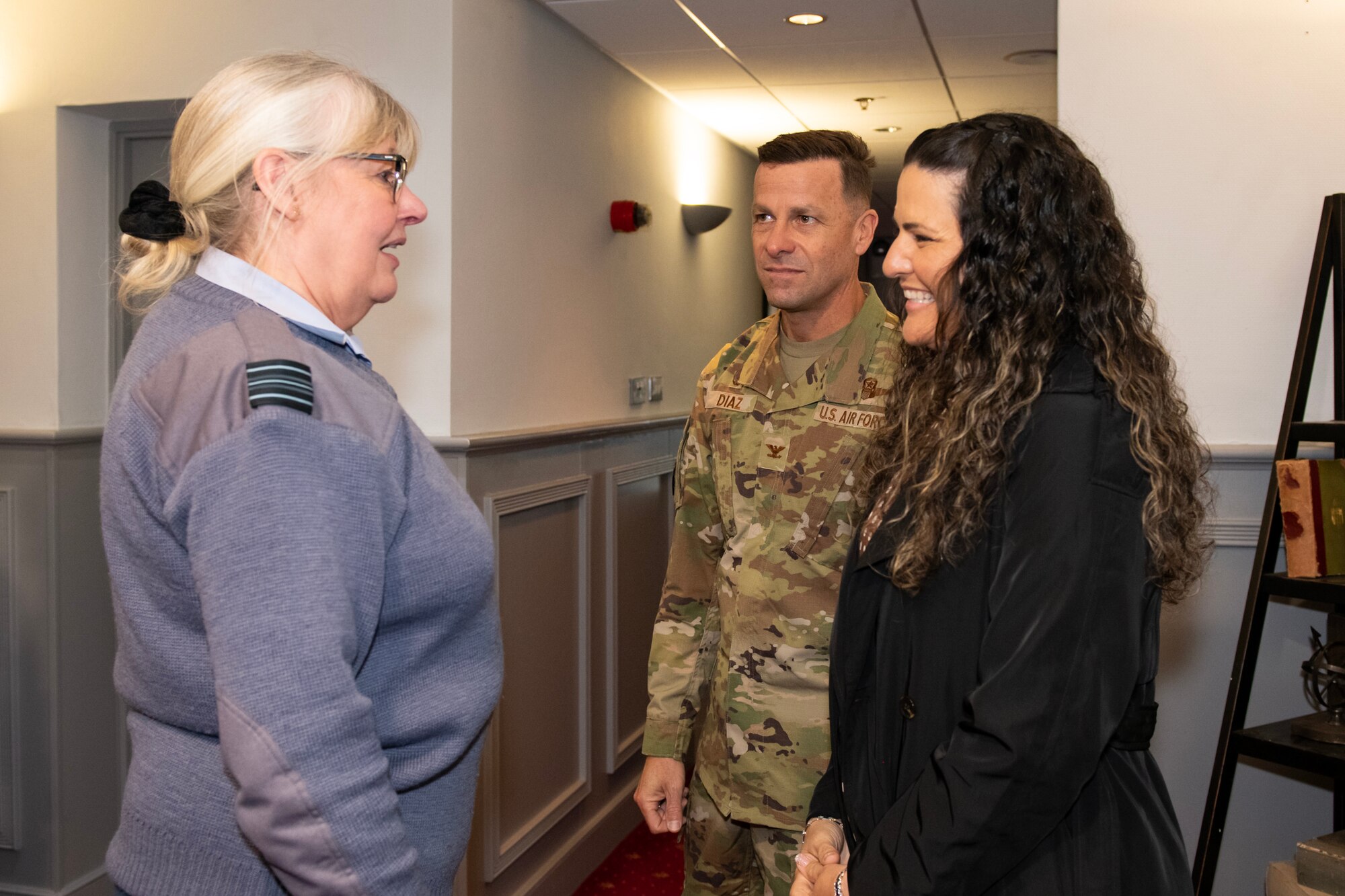 U.S. Air Force Col. Ricardo Diaz, center, 422d Air Base Group commander, and his spouse greet Royal Air Force Sq. Ldr. Jayne Robertson, RAF commander