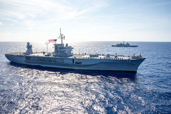 USS Blue Ridge (LCC 19), left, is underway with the French navy in the Philippine Sea during Valiant Shield 2024.