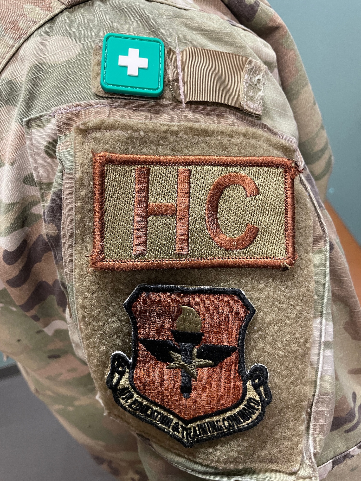 A green first-aid recognition tab sticks to the shoulder of a U.S. Air Force OCP uniform, June 11, 2024, at Luke AFB, Arizona.
