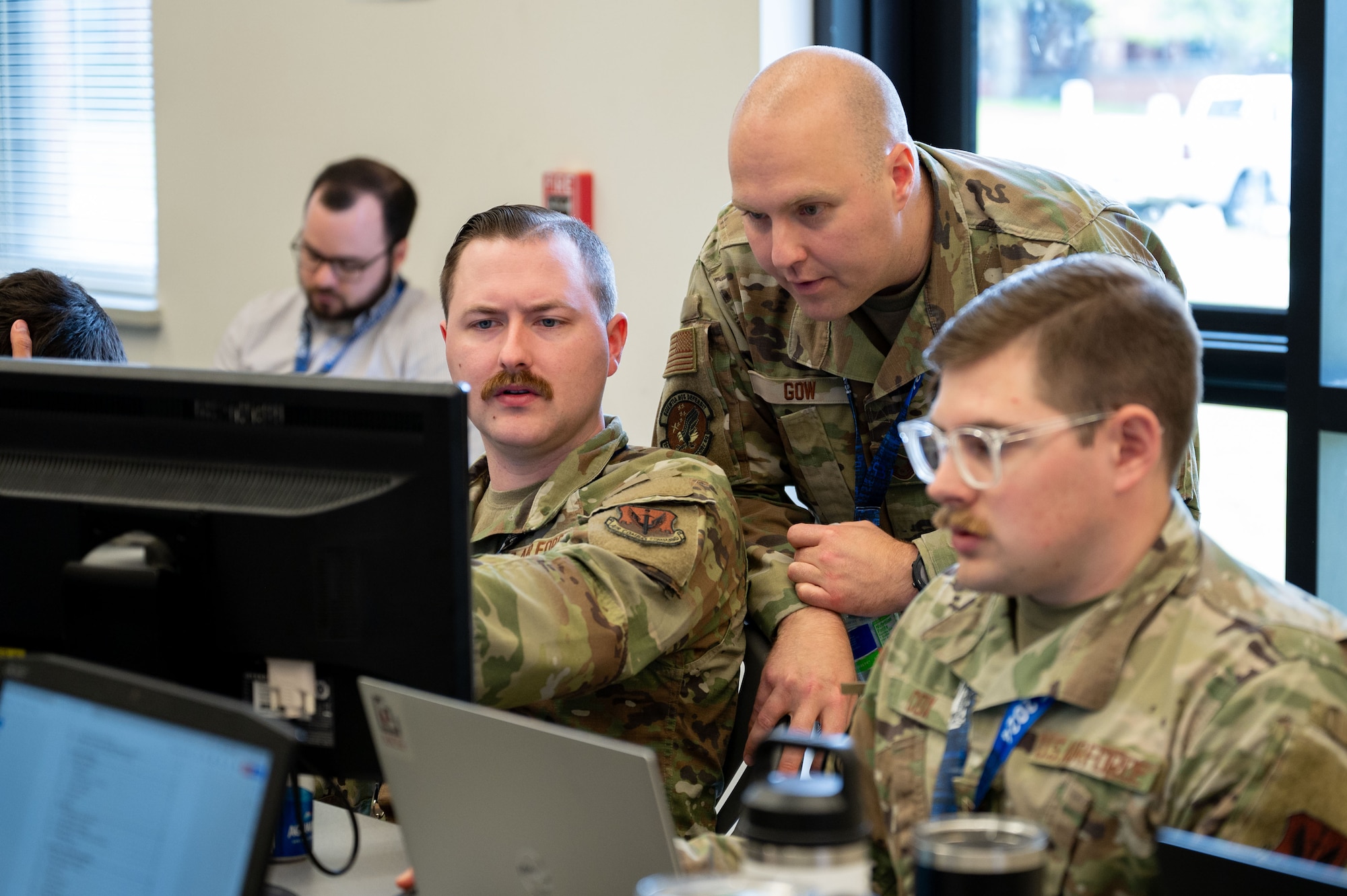 Airmen type on computers.
