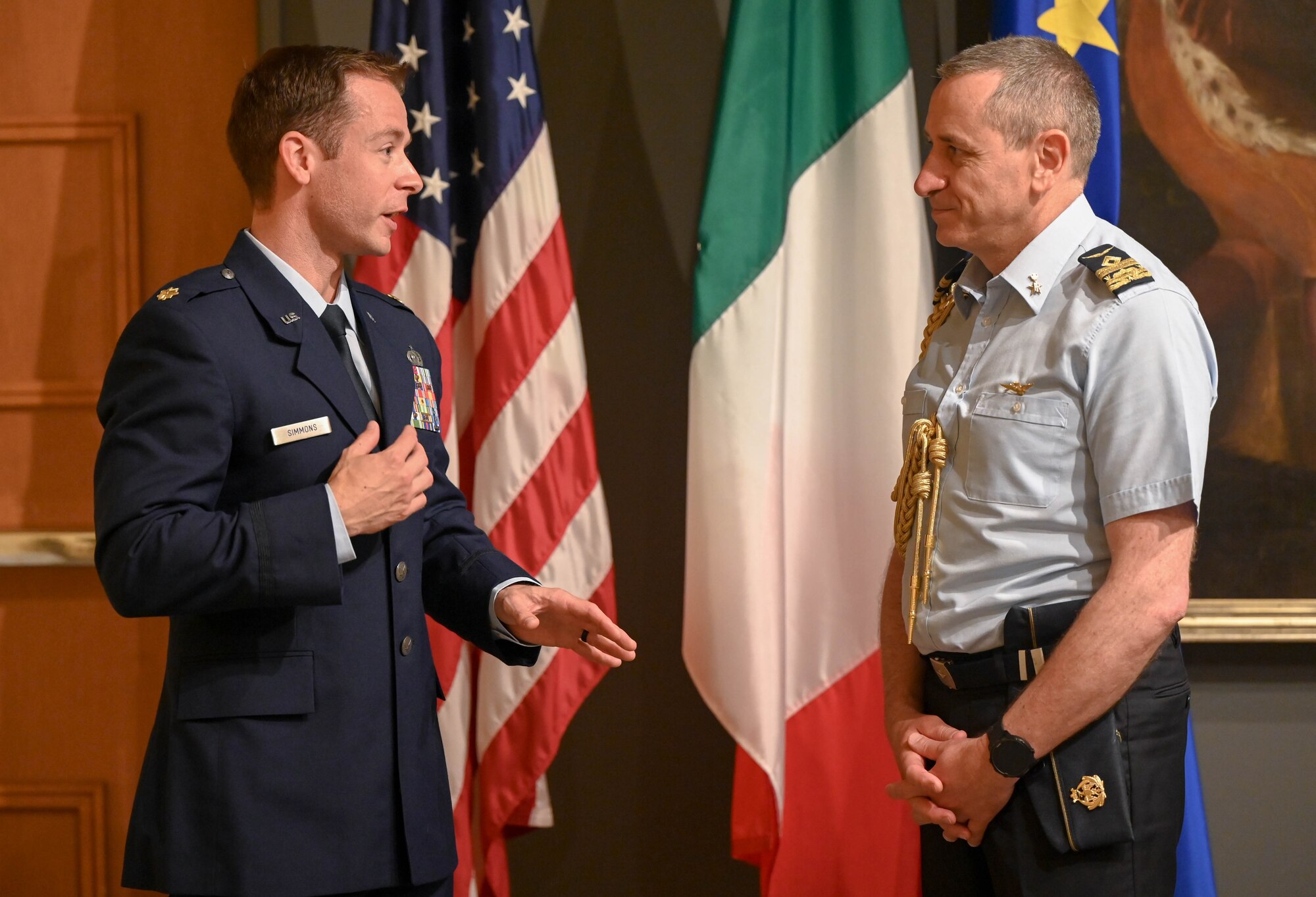 Two men speak to each other.