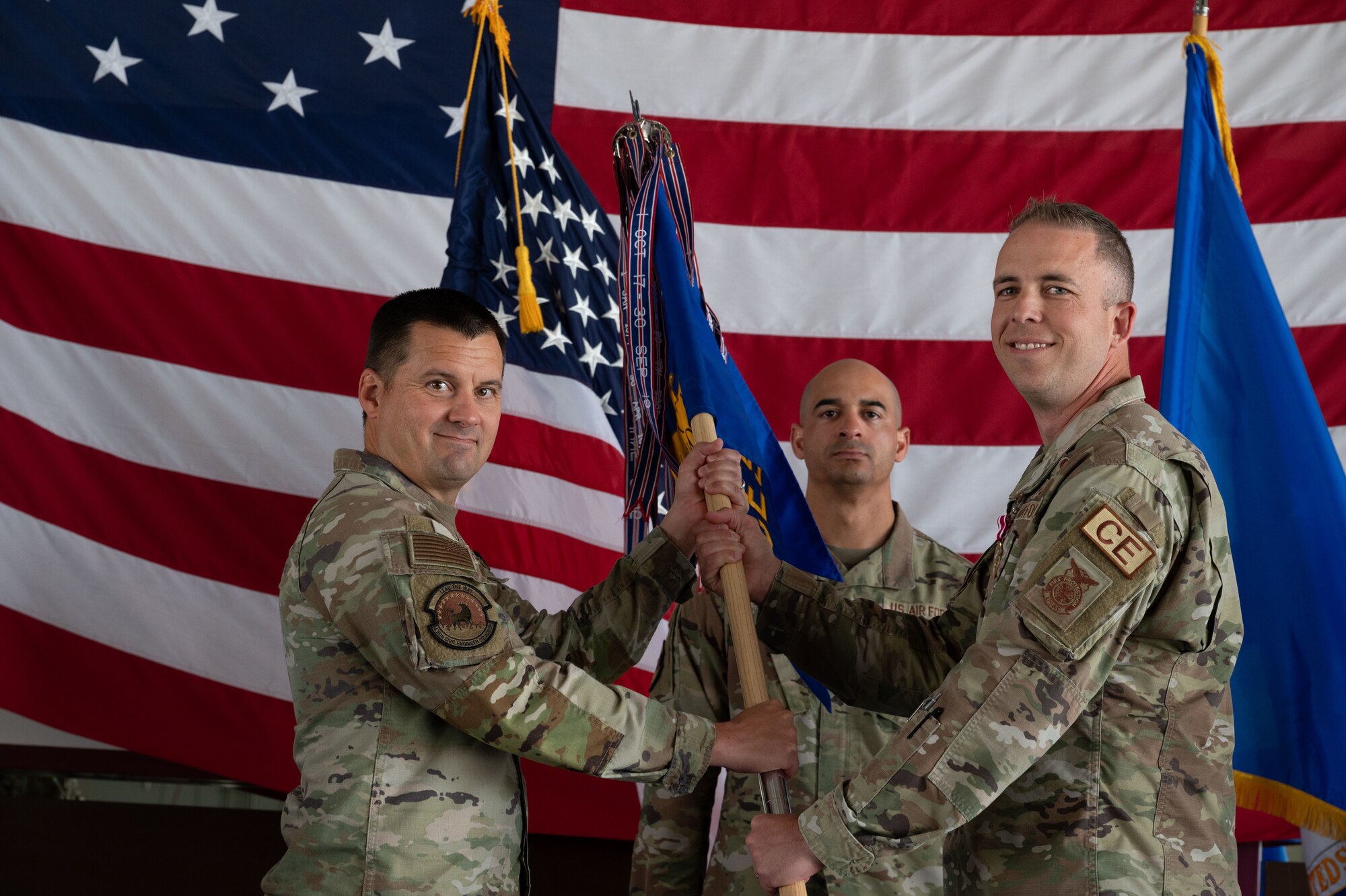 U.S. Air Force Lt. Col. Joshua Yerk, right, outgoing 436th Civil Engineer Squadron commander, relinquishes command to Col. Jason Holcomb, 436th Mission Support Group commander, during a change of command ceremony at Dover Air Force Base, Delaware, June 13, 2024. The ceremony saw Yerk relinquish command to Lt. Col. Robert Shuler. (U.S. Air Force photo by Dieondiere Jefferies)