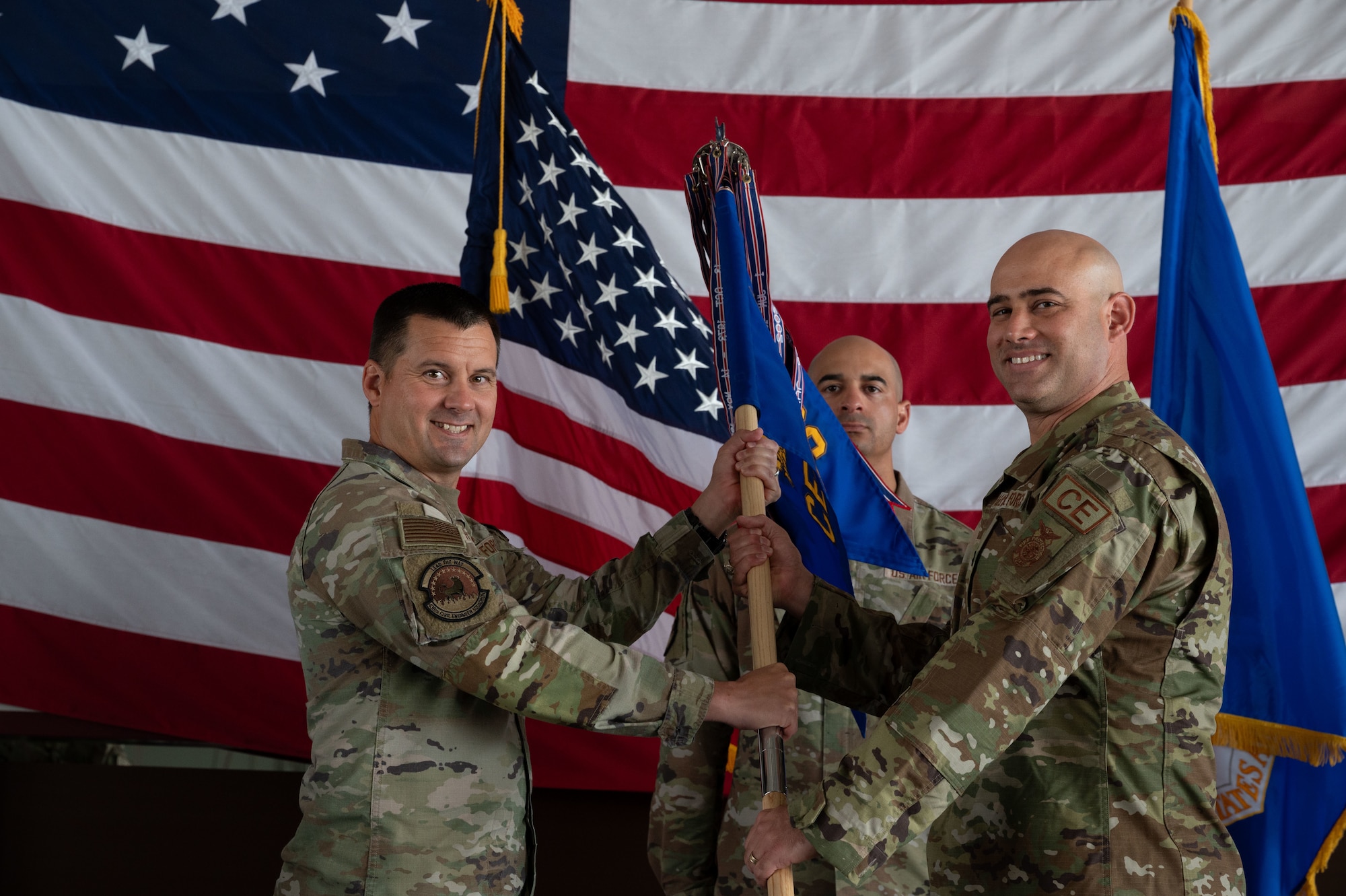 U.S. Air Force Col. Jason Holcomb, left, 436th Mission Support Group, passes the guidon to Lt. Col. Robert Shuler, incoming 436th Civil Engineer Squadron commander, during a change of command ceremony at Dover Air Force Base, Delaware, June 13, 2024. The ceremony saw Lt. Col. Joshua Yerk relinquish command to Shuler. (U.S. Air Force photo by Dieondiere Jefferies)
