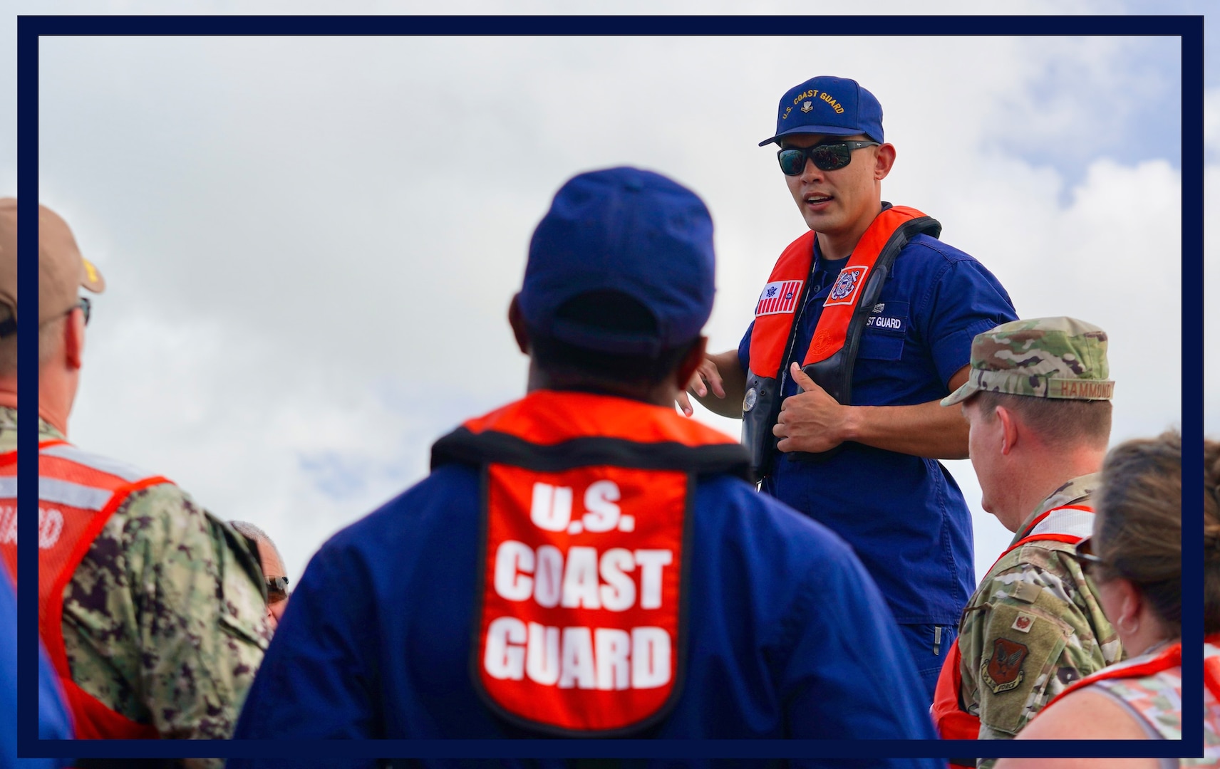 Petty Officer 2nd Class Will Naden, a boatswains mate at Station Apra Harbor, gives a safety brief to Department of Defense personnel in Sumay Cove, Guam, ahead of a boat trip to view the Outer Apra Harbor breakwater on Dec. 4, 2023. The breakwater was damaged by Typhoon Mawar and an effort is underway to effect repairs. (U.S. Coast Guard photo by Chief Warrant Officer Sara Muir)