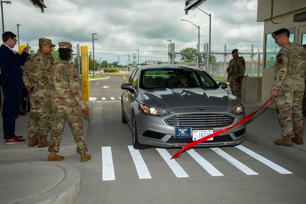 U.S. Air Force Col. Joseph Contino, 914th Air Refueling Wing commander, drives his staff vehicle through a ribbon at the new main gate facility on Niagara Falls Air Reserve Station May 29, 2024.