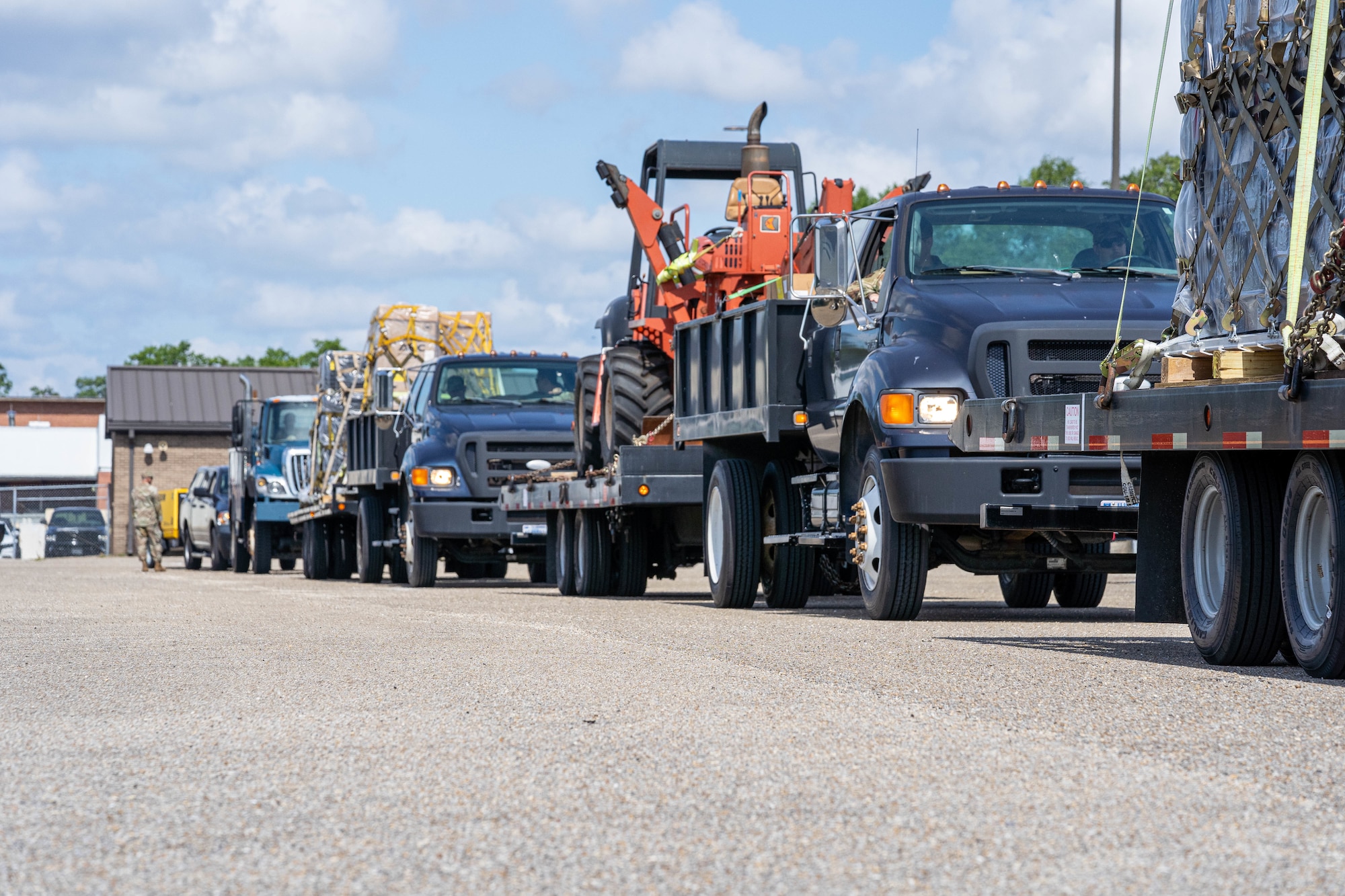 Multiple vehicles carrying heavy equipment head to another installation for the Cyberspace Infrastructure Damage Assessment and Restoral Actions Exercise at the 85th Engineering Installation Squadron, May 21, 2024.