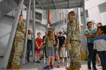 Spouses and kids are given a tour of C-17 Globemaster III training devices.