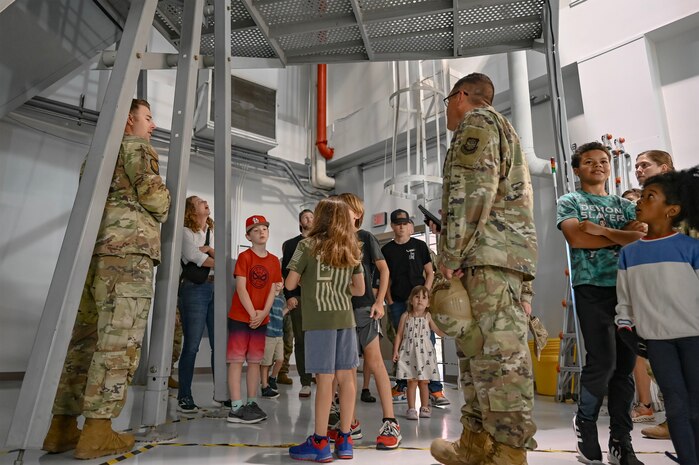 Spouses and kids are given a tour of C-17 Globemaster III training devices.