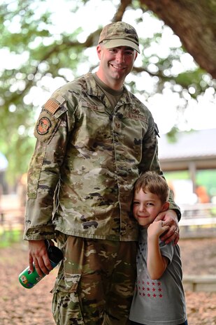 Airman and his son pose for a photo