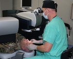 Maj. Gregory Giles, BACH Clinic Chief and Ophthalmologist performs refractive eye surgery on a Fort Campbell Soldier.