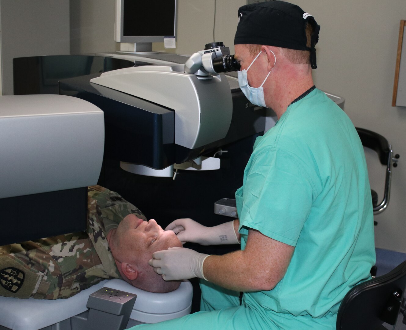 Maj. Gregory Giles, BACH Clinic Chief and Ophthalmologist performs refractive eye surgery on a Fort Campbell Soldier.