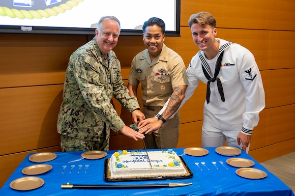 Rear Adm. Darin Via, Navy Surgeon General, Force Master Chief PatrickPaul Mangaran, director of the Hospital Corps, and Hospital Corpsman 3rd Class Alexander Brady, the Bureau of Medicine and Surgery Blue Jacket of the Year, cut a ceremonial cake during the 126th Hospital Corps birthday at the Defense Health Headquarters in Falls Church, Virginia, June 17.