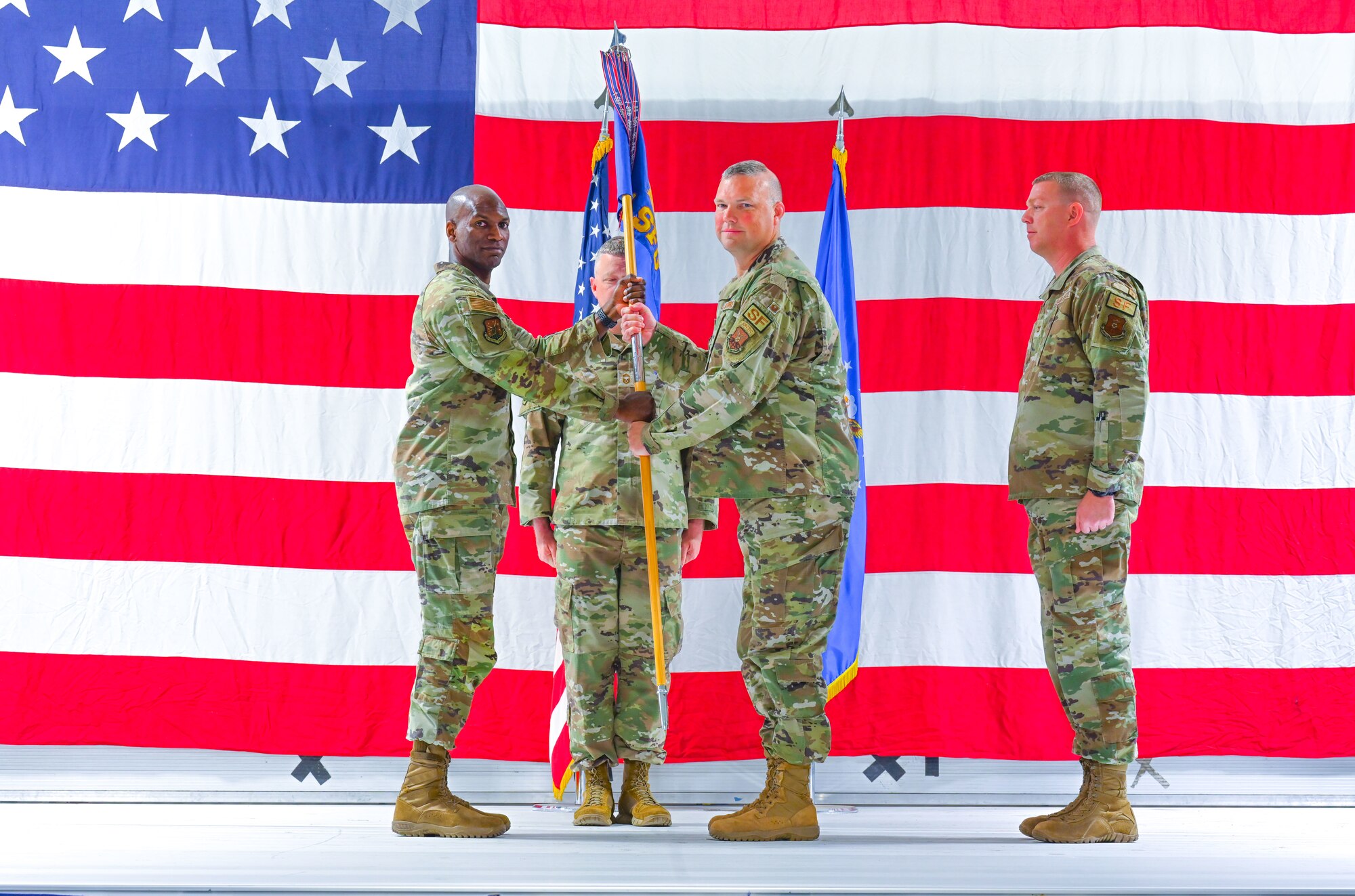 U.S. Air Force Col. James Slaton accepts command of the 91st Security Forces Group (SFG) from Col. Kenneth McGhee, 91st Missile Wing (MW) commander, at Minot Air Force Base, North Dakota, June 17, 2024. The 91st SFG is responsible for safeguarding 91st MW assets.