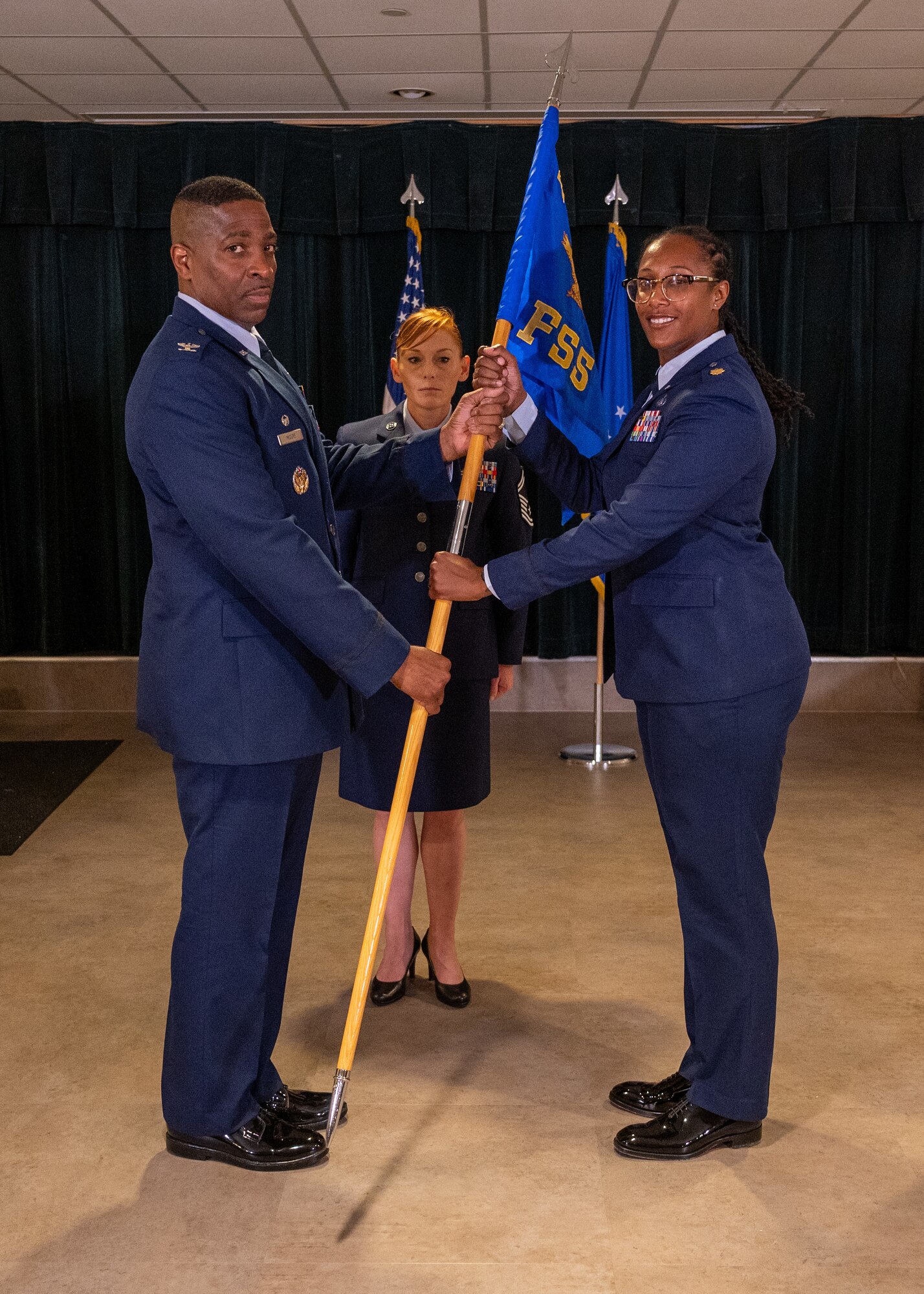 U.S. Air Force Col. Robert Moore (left), 47th Mission Support Group commander, presents the guidon to Maj. Micah Dalcoe (right), 47th Force Support Squadron (FSS) commander, during the 47th FSS change of command ceremony at Laughlin Air Force Base, Texas, June 11, 2024. Change of command ceremonies represent a formal transfer of authority and responsibility for a unit from one commanding officer to another. (U.S. Air Force photo by Staff Sgt. Nicholas Larsen)