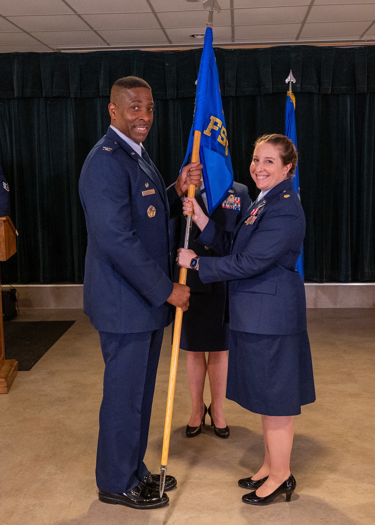 U.S. Air Force Col. Robert Moore (left), 47th Mission Support Group commander, accepts the guidon from Maj. Kayleigh Stilwell (right), 47th Force Support Squadron (FSS) commander, during the 47th FSS change of command ceremony at Laughlin Air Force Base, Texas, June 11, 2024. Change of command ceremonies represent a formal transfer of authority and responsibility for a unit from one commanding officer to another. (U.S. Air Force photo by Staff Sgt. Nicholas Larsen)