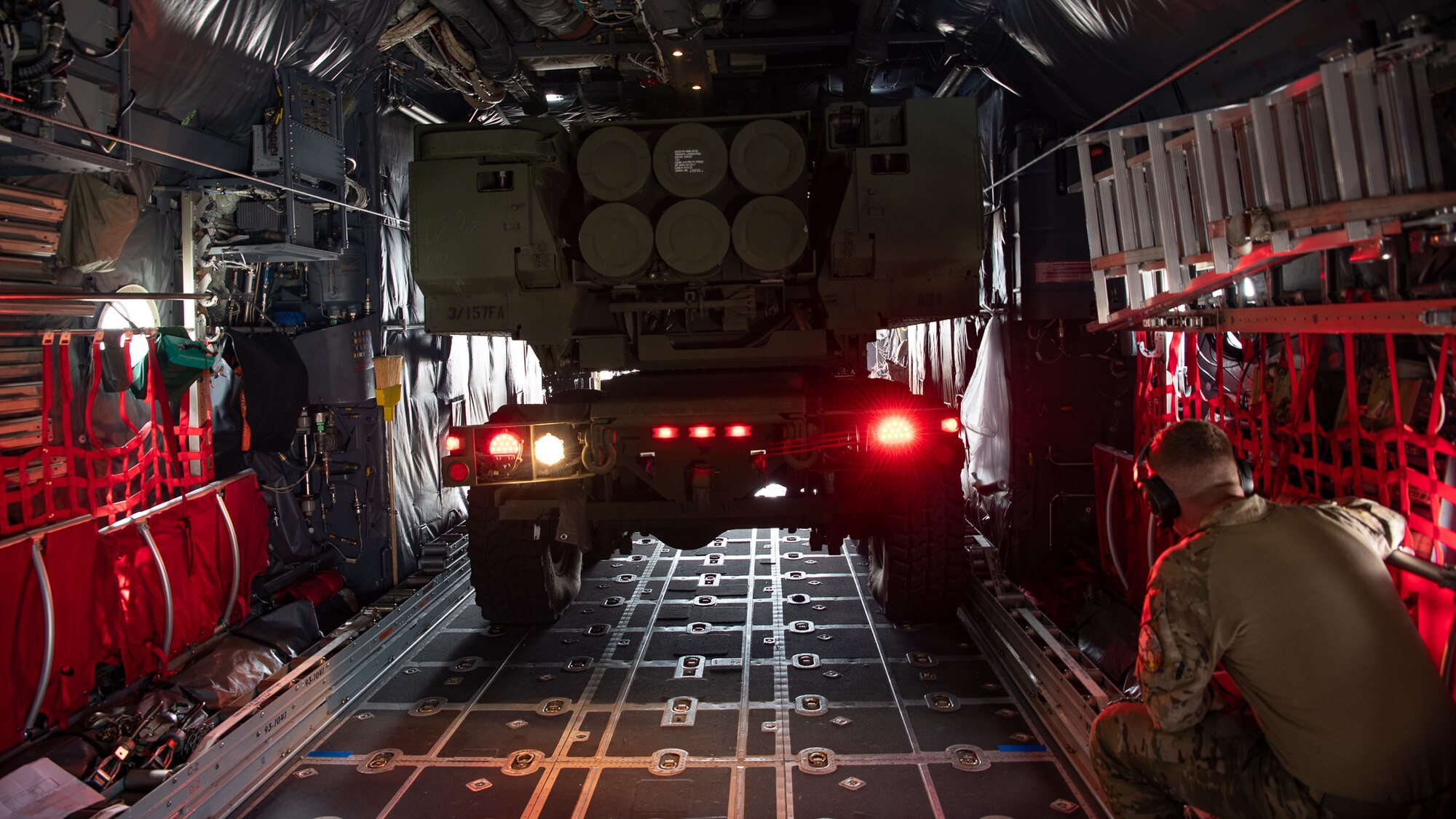 A truck with six rocket canisters inside of a cargo bay.