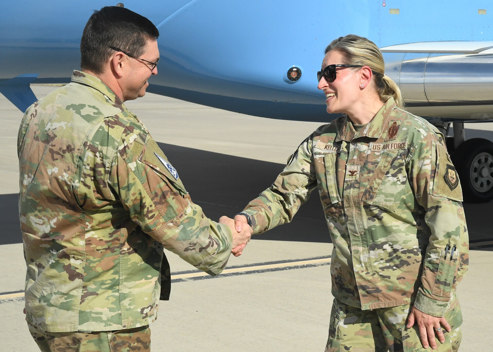 Man shakes woman hand.