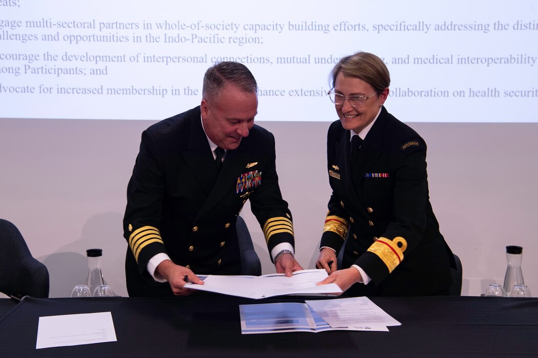 Australian Rear Adm. Sonya Bennett, Australian Defence Force surgeon general, right, and U.S. Navy Capt. Jeffrey Bitterman, command surgeon at U.S. Indo-Pacific Command, right, sign the Indo-Pacific health security alliance Terms of Reference at the Military Civilian Health Security Summit co-hosted by the Australian Defence Force and U.S. Indo-Pacific Command in Sydney, June 17, 2024.