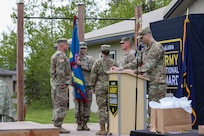Lt. Col. Chad Ausel, outgoing commander of the Recruiting and Retention Battalion, Alaska Army National Guard, holds the battalion colors for the final time during a change of command ceremony held at Camp Carroll on Joint Base Elmendorf-Richardson, Alaska, May 31, 2024.
