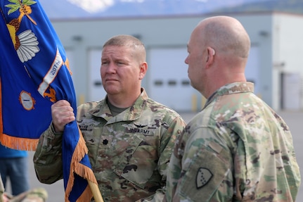 Alaska Army National Guard Lt. Col. Todd Miller, the outgoing commander of the 207th Aviation Troop Command, holds his unit’s colors during the unit’s change of command ceremony at Bryant Army Airfield on Joint Base Elmendorf-Richardson, June 2, 2024.