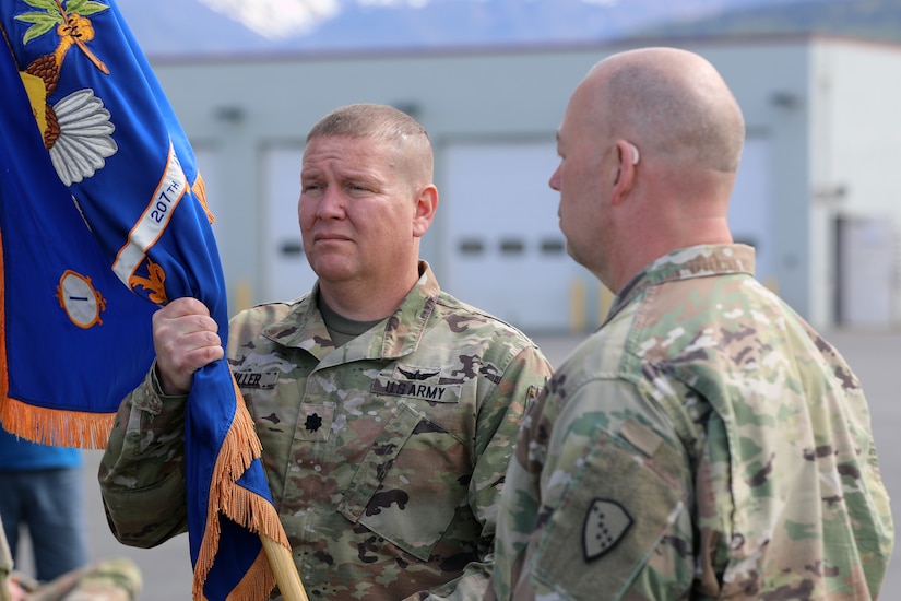 Alaska Army National Guard Lt. Col. Todd Miller, the outgoing commander of the 207th Aviation Troop Command, holds his unit’s colors during the unit’s change of command ceremony at Bryant Army Airfield on Joint Base Elmendorf-Richardson, June 2, 2024.