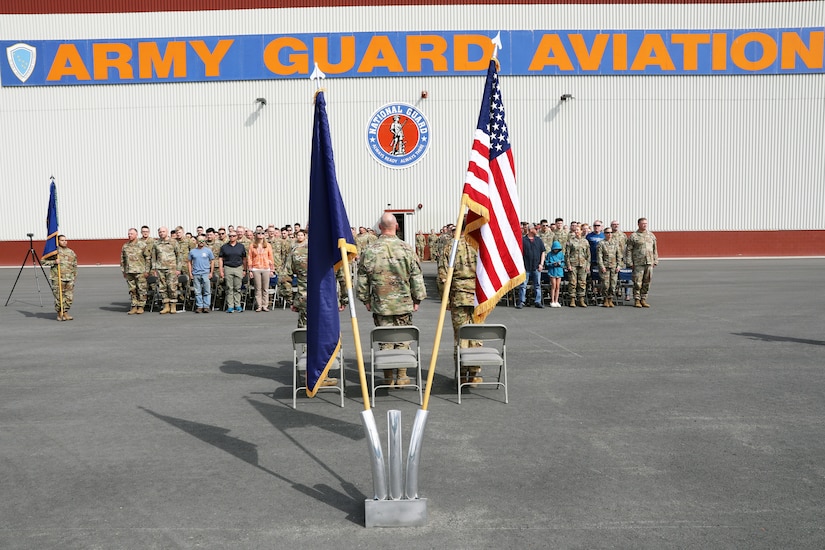 Alaska Army National Guard Soldiers, retirees and loved ones stand for the playing of the Army Song during the 207th Aviation Troop Command Change of Command Ceremony at Bryant Army Airfield on Joint Base Elmendorf-Richardson, June 2, 2024.