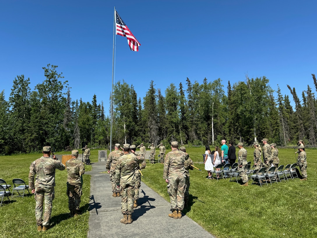 Alaska Army National Guardsmen, friends, and family gather at Camp Carroll flagpole to watch the 207th Multi-Functional Training Regiment change of command ceremony on Joint Base Elmendorf-Richardson, Alaska, June 16, 2024.