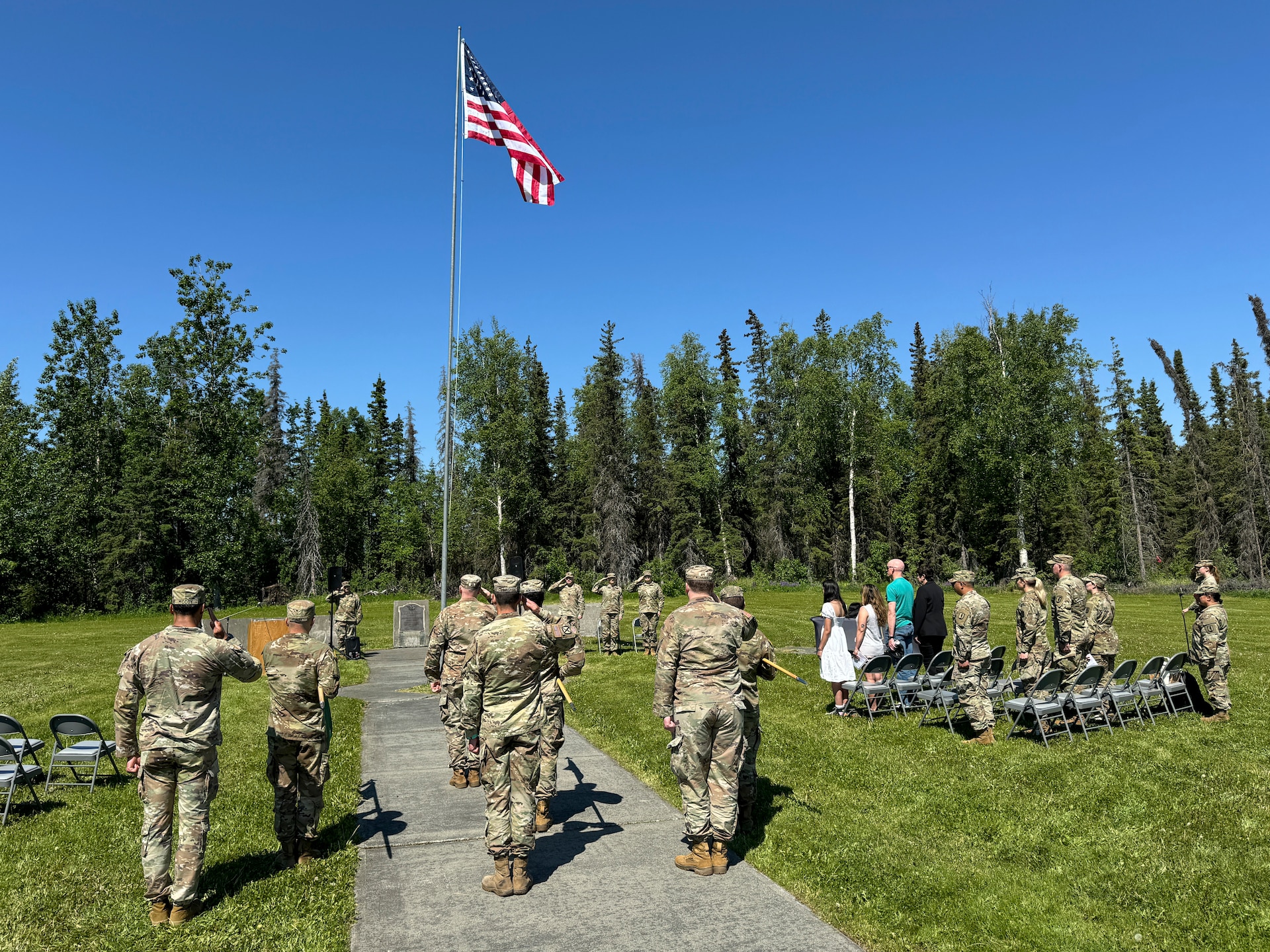 Alaska Army National Guardsmen, friends, and family gather at Camp Carroll flagpole to watch the 207th Multi-Functional Training Regiment change of command ceremony on Joint Base Elmendorf-Richardson, Alaska, June 16, 2024.