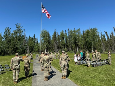 Alaska Army National Guardsmen, friends, and family gather at Camp Carroll flagpole to watch the 207th Multi-Functional Training Regiment change of command ceremony on Joint Base Elmendorf-Richardson, Alaska, June 16, 2024.