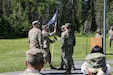 Alaska Army National Guard Lt. Col. Aaron Hamilton, left, 207th Multi-Functional Training Regiment outgoing commander, passes his unit’s colors to Col. Michele Edwards, 297th Regional Support Group commander, signifying the end of his command during a change of command ceremony at the Camp Carroll flagpole on Joint Base Elmendorf-Richardson, June 16, 2024.