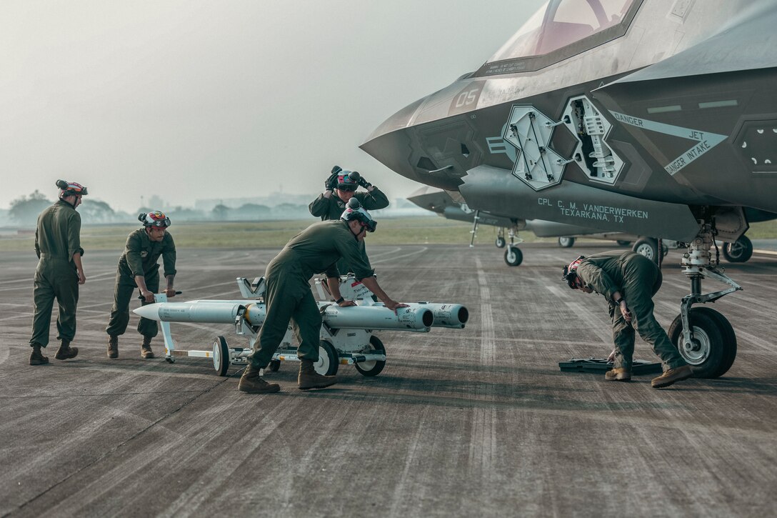 U.S. Marines with Marine Fighter Attack Squadron (VMFA) 214, Marine Aircraft Group 13, 3rd Marine Aircraft Wing, assemble a GBU-32 joint direct attack munition onto a U.S. Marine Corps F-35B Lightning II with VMFA-214, MAG 13, 3rd MAW, before a littoral live-fire exercise off the coast of Ilocos Norte and Zambales during Marine Aviation Support Activity 24 on Clark Air Base, Philippines, June 15, 2024. The LLFX showcased the integrated command and control capabilities of the U.S. and Philippine Armed Forces in a territorial defense scenario featuring a coordinated bilateral and maritime strike. MASA is an annual Philippine-U.S. military exercise focused on mutual defense, strengthening relationships, and rehearsing emerging aviation concepts. (U.S. Marine Corps photo by Sgt. Shaina Jupiter)
