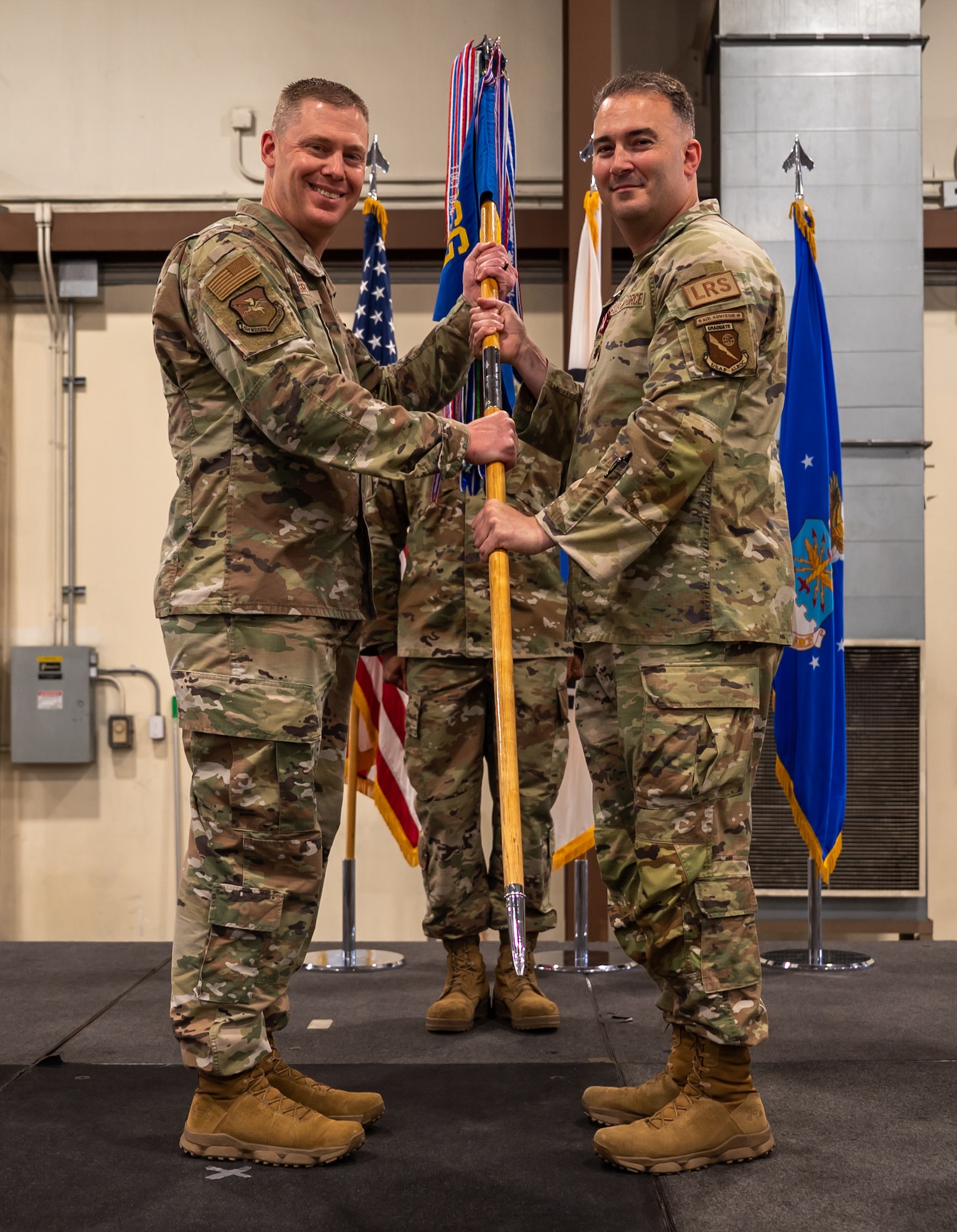 U.S. Air Force Lt. Col. Vincent McLean, right, relinquishes command of the 51st Logistics Readiness Squadron to Col. Kyle Grygo, left, 51st Mission Support Group commander, during a change of command ceremony at Osan Air Base, Republic of Korea, June 14, 2024. After relinquishing command, McLean will attend School of Advanced Air and Space Studies at Maxwell Air Force Base, Alabama. (U.S. Air Force photo by Senior Airman Brittany Russell)