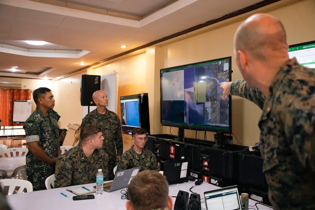 U.S. Marine Corps Brig. Gen. Robert B. Brodie, right, the commanding general of I Marine Expeditionary Force (Forward), and Philippine Marine Corps Brig. Gen. Romeo T. Racadio, left, the deputy commandant of the Philippine Marine Corps, monitor video livestreams at the command and control center during the littoral live-fire exercise for Marine Aviation Support Activity 24 at Fort Bonifacio, Manila, Philippines, June 15, 2024. The LLFX showcased the integrated command and control capabilities of the U.S. and Philippine armed forces in a territorial defense scenario featuring a coordinated bilateral surface and maritime strike. MASA is an annual Philippine-U.S. military exercise focused on mutual defense, strengthening relationships, and rehearsing emerging aviation concepts. (U.S. Marine Corps photos by Cpl. Kayla Halloran)